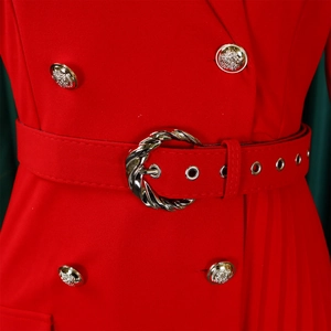 Detailed macro view of red pleated dress featuring gold crest buttons and silver ring belt
