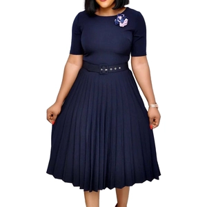 Detail of navy blue pleated dress with classic round neck and decorative floral brooch
