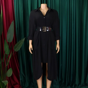 Detail of black shirt dress featuring a high-low hem and transparent PVC belt with gold buckle