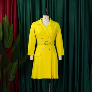 Detailed view of yellow blazer dress featuring a double-breasted closure and side pleats