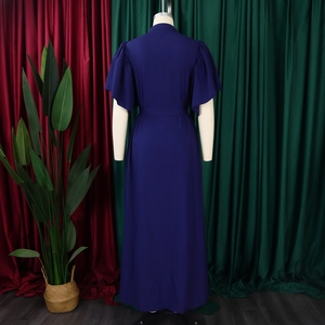 Detail of elegant dark blue maxi dress featuring flared sleeves and a high waisted belt design