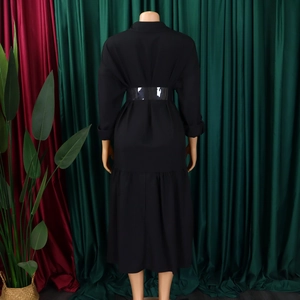 Back view of a black long-sleeved midi shirt dress with a wide glossy belt on a mannequin