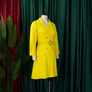 Detail of high waist pleated blazer dress in yellow with double-breasted buttons and belt