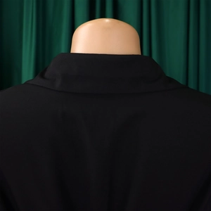 Detail view of the flat collar and high-quality woven fabric on a black shirt dress