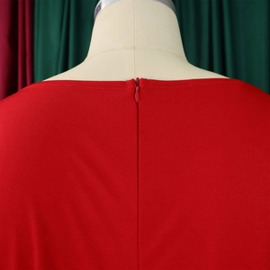 Detail of invisible back zipper closure on elegant red wide-leg jumpsuit with fine texture