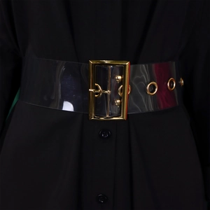 Detail of transparent PVC waist belt with gold rectangle buckle and metal eyelets on black dress