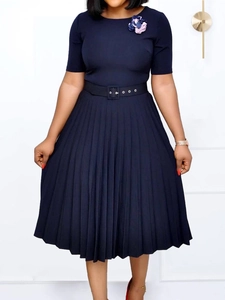 Elegant navy blue short sleeve pleated dress with waist belt and flower brooch detail
