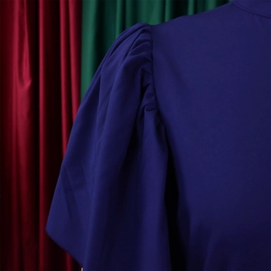 Detail of dark blue summer dress showing elegant puff sleeve and fine stitching quality
