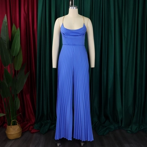 Detail of royal blue pleated jumpsuit with gold chain neck and draped halter neck collar