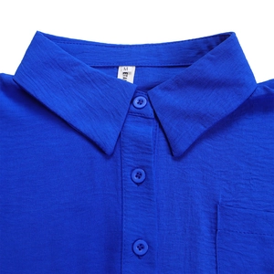 Detail of royal blue short sleeve shirt featuring classic lapel collar and chest pocket