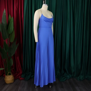 Close-up of blue jumpsuit with metal chain strap and pleated fabric detail