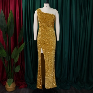 Detail of shimmering gold sequins and high-slit design on an elegant one-shoulder evening gown
