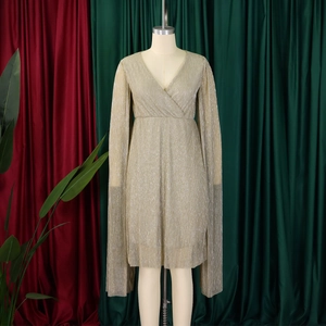 Detail of elegant V-neck champagne gold pleated evening gown with cape sleeves
