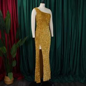 Close-up of golden sequins on a sleek one-shoulder dress with a high side slit