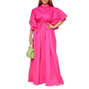 Detail of fuchsia shirt dress featuring dramatic puff sleeves and a matching tie belt