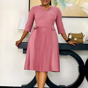 Detail of dusty rose pleated dress featuring half sleeves and V-neckline in a modern setting