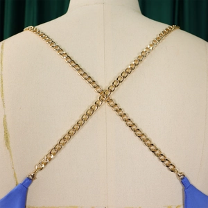 Detail of gold metal chain halter neck strap with lobster clasp on a backless jumpsuit