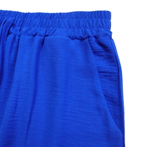 Detail of blue casual shorts with elastic drawstring waist and textured crepe fabric