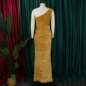Close-up of sparkling gold sequins on the asymmetrical one-shoulder evening gown