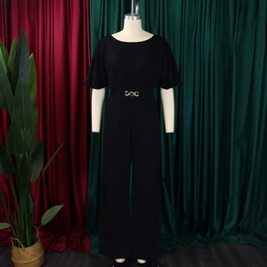 Detail of elegant black jumpsuit featuring a decorative double-ring gold waist buckle