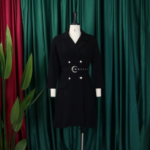 Close-up of black double-breasted blazer dress with gold buttons and waist belt