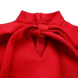 Close-up of red dress neckline with tie-up bow, small stand collar and V-neckline detail