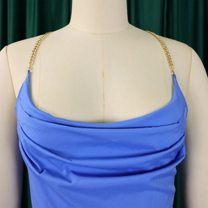 Detail of royal blue cowl neck jumpsuit with golden metal chain strap and pleated fabric
