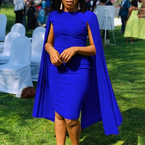Detail of royal blue pleated cape sleeves on a slim-fit evening party midi dress