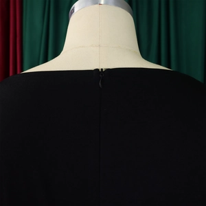 Detail of hidden back zipper on a black high-waisted wide-leg jumpsuit for women
