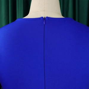 Detail of the hidden back zipper and texture on a royal blue pleated evening dress