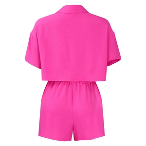Back view of a rose pink two-piece set featuring short-sleeve shirt and elastic shorts