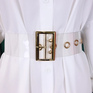 Close-up of a clear PVC wide belt with gold square buckle over a white shirt