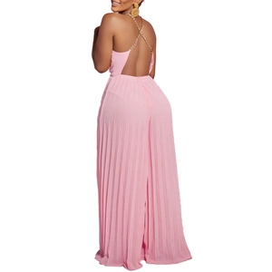 Close-up of pink pleated jumpsuit featuring elegant gold metal chain halter straps