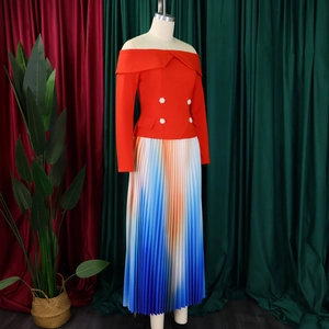 Detail of elegant off-shoulder red top with pearl buttons and pleated gradient skirt