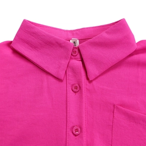Close-up of rose red lapel shirt detail showing fabric texture and matching buttons