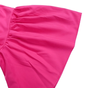 Detailed close-up of pink flared sleeve cuff with delicate ruffles and fine stitching