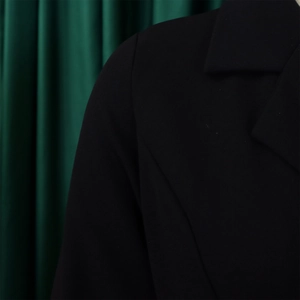 Detail of high waist blazer dress featuring refined shoulder seams and elegant lapels