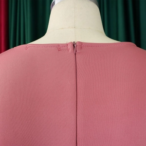 Detail of invisible zipper closure on the back of this dusty pink ruffle dress