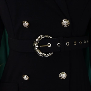 Detail of high waist blazer dress featuring silver twist buckle and embossed gold buttons