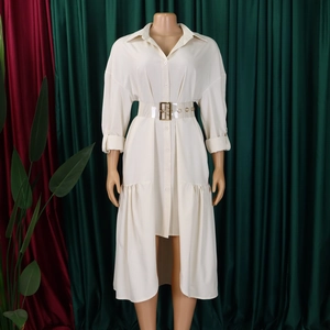 Detail of cream shirt dress with high-low hem and transparent belt with gold buckle