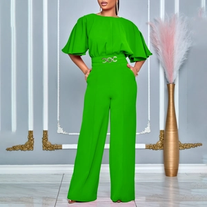 Detail of bright green jumpsuit featuring ruffle sleeves and waist belt with silver buckle
