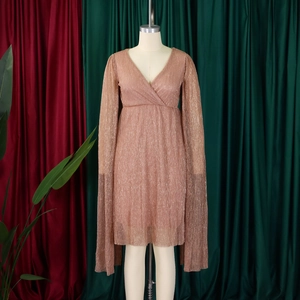 Detail of elegant rose gold pleated dress with deep V-neck and draped cape sleeves