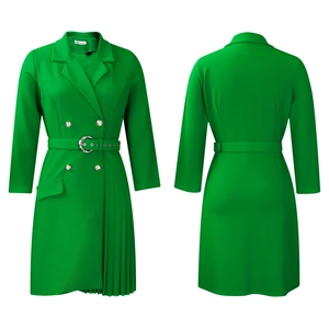 Detail of high-waist green blazer dress featuring silver petal buckle and pleated skirt