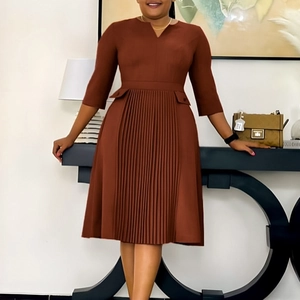 Close-up of brown V-neck dress featuring pleated details and stylish three-quarter sleeves