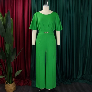 Detail of green wide-leg jumpsuit showing round neck design and waist belt with golden rings