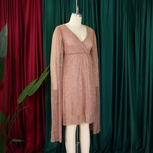 Detail of elegant V-neck pleated evening dress with shimmering cape-style long sleeves