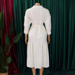 Back view of beige shirt dress featuring elastic waist pleats and ruffled hemline detail