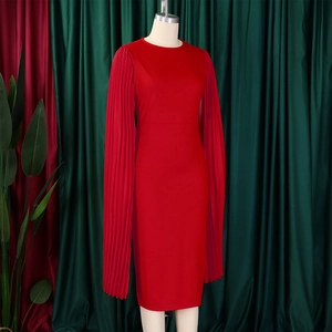 Detail of red fitted evening dress featuring elegant pleated floor-length cape sleeves