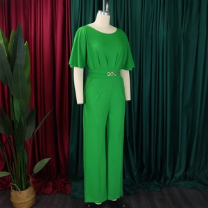 Detail of lime green high waist jumpsuit featuring three gold ring buckles on the belt