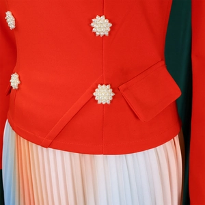 Detail of red off-shoulder top with pearl flower buttons and gradient pleated skirt